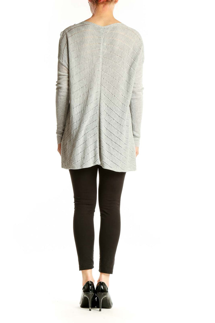 Side view of Eileen Fisher gray V-neck chevron knit sweater on model
