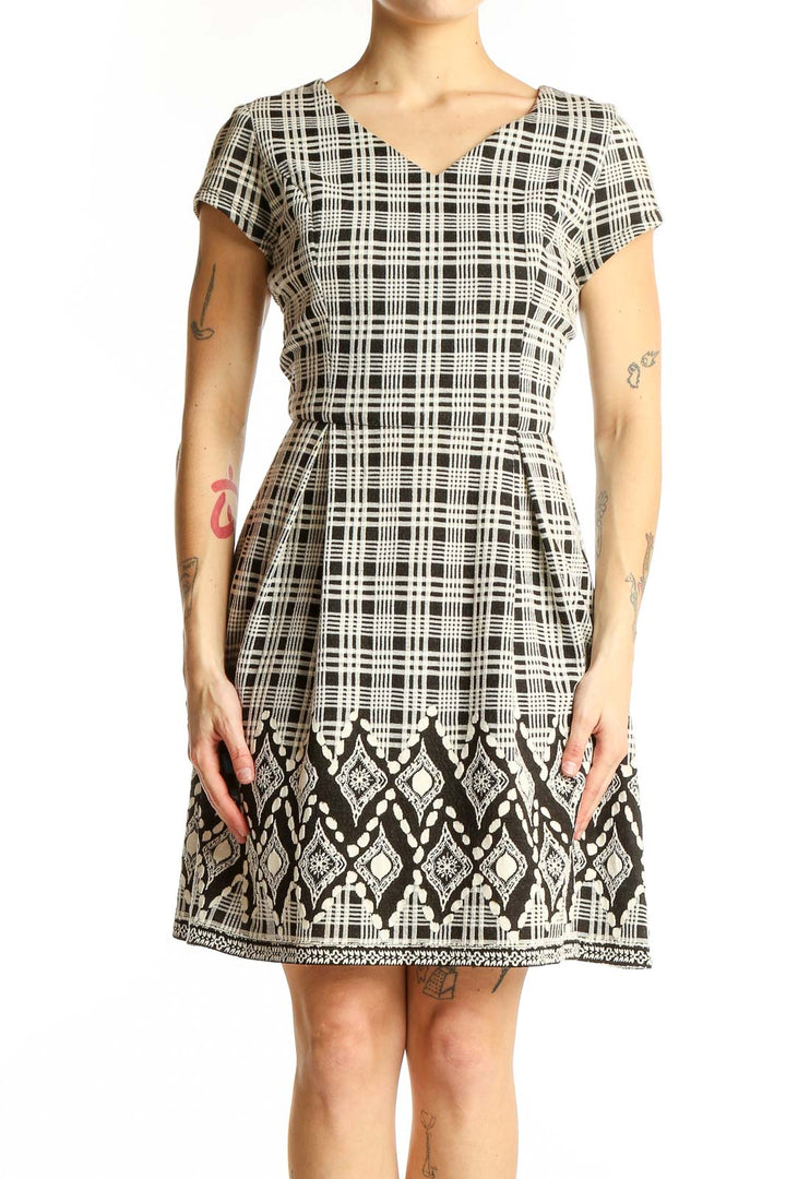 Front view of 41 Hawthorn black and white plaid A-line dress with geometric border