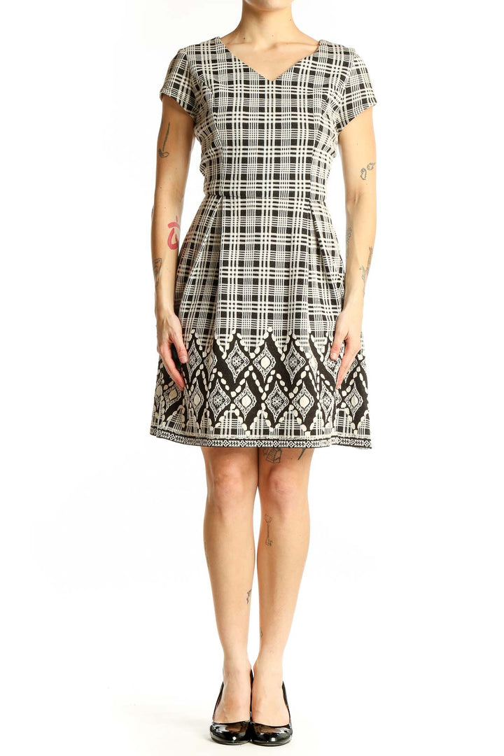 Front view of 41 Hawthorn black and white plaid A-line dress with geometric border