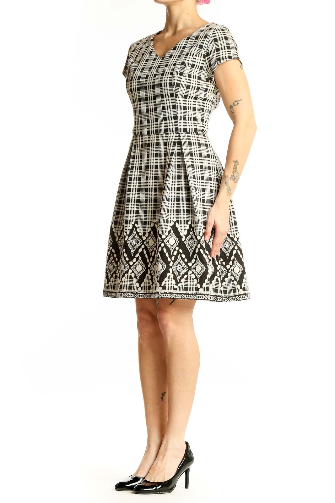 Front view of 41 Hawthorn black and white plaid A-line dress with geometric border