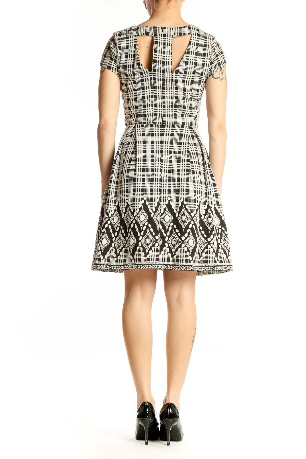 Side view of 41 Hawthorn black and white plaid A-line dress showing geometric border detail