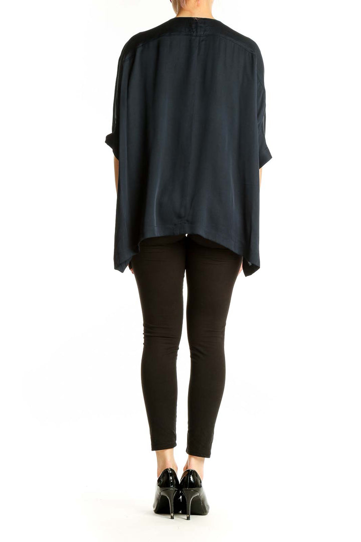 Side view of black oversized Vince blouse showing dolman sleeves and drape