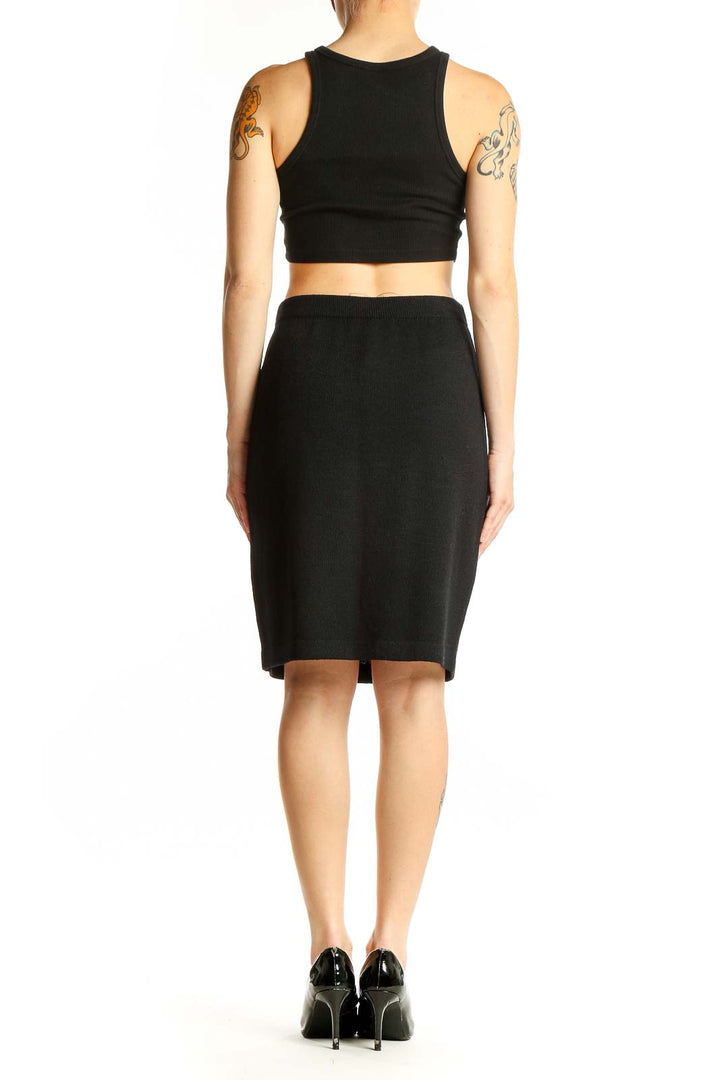 Back view of black St. John pencil skirt with matching crop top