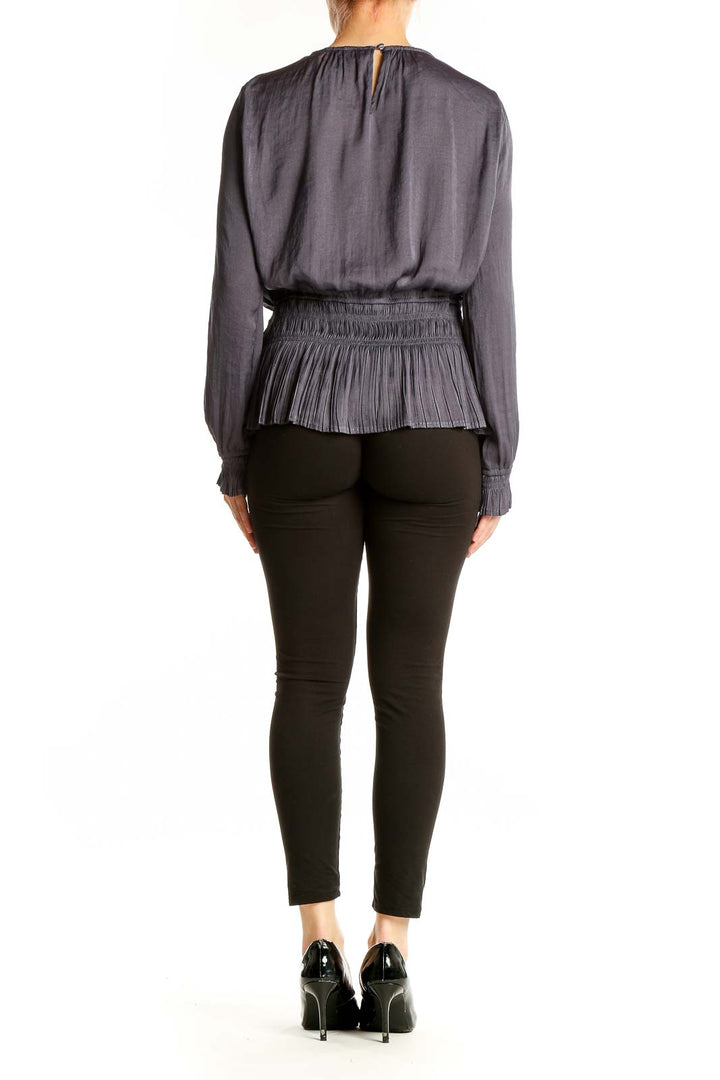 Side view of Tahari gray pleated peplum blouse showing peplum detail