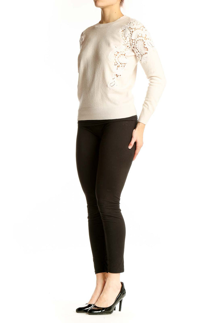 Front view of Ted Baker London cream sweater with lace detailing on shoulders