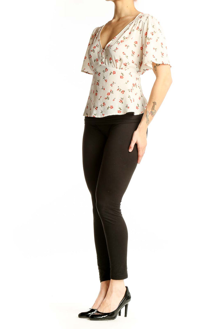 Front view of cream Papermoon blouse with coral floral print and flutter sleeves