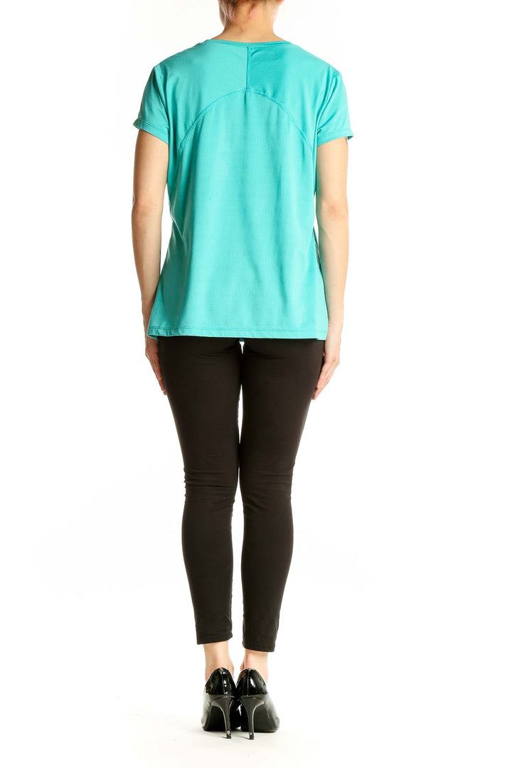Back view of teal Columbia short-sleeve athletic top on model