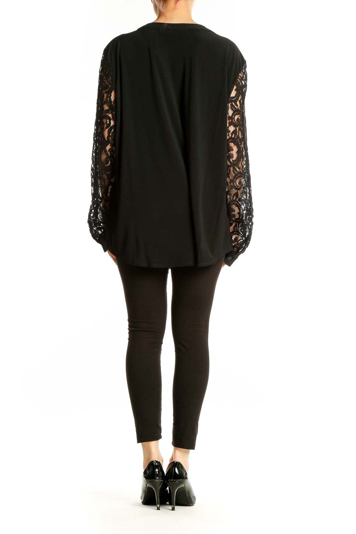 Side view of Kasper black tunic top showing lace sleeve detail