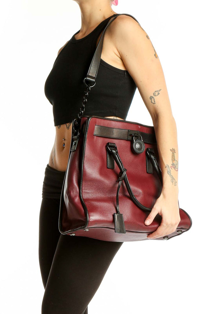 Front view of Michael Kors burgundy leather tote bag with black accents