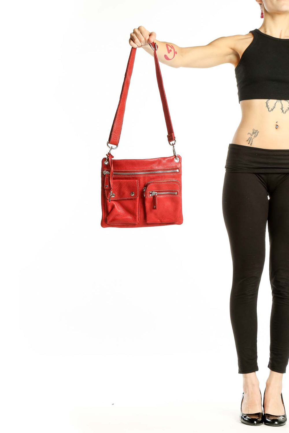 Front view of red leather Fossil crossbody bag with multiple zippered pockets