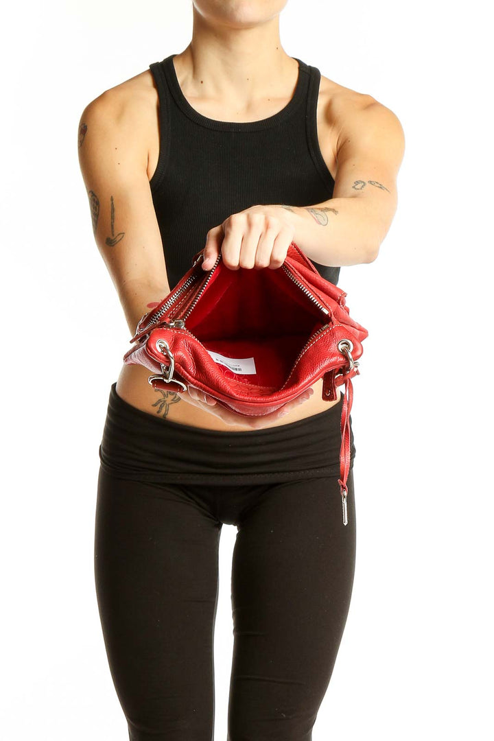 Side view of red Fossil crossbody bag worn by model showing adjustable strap