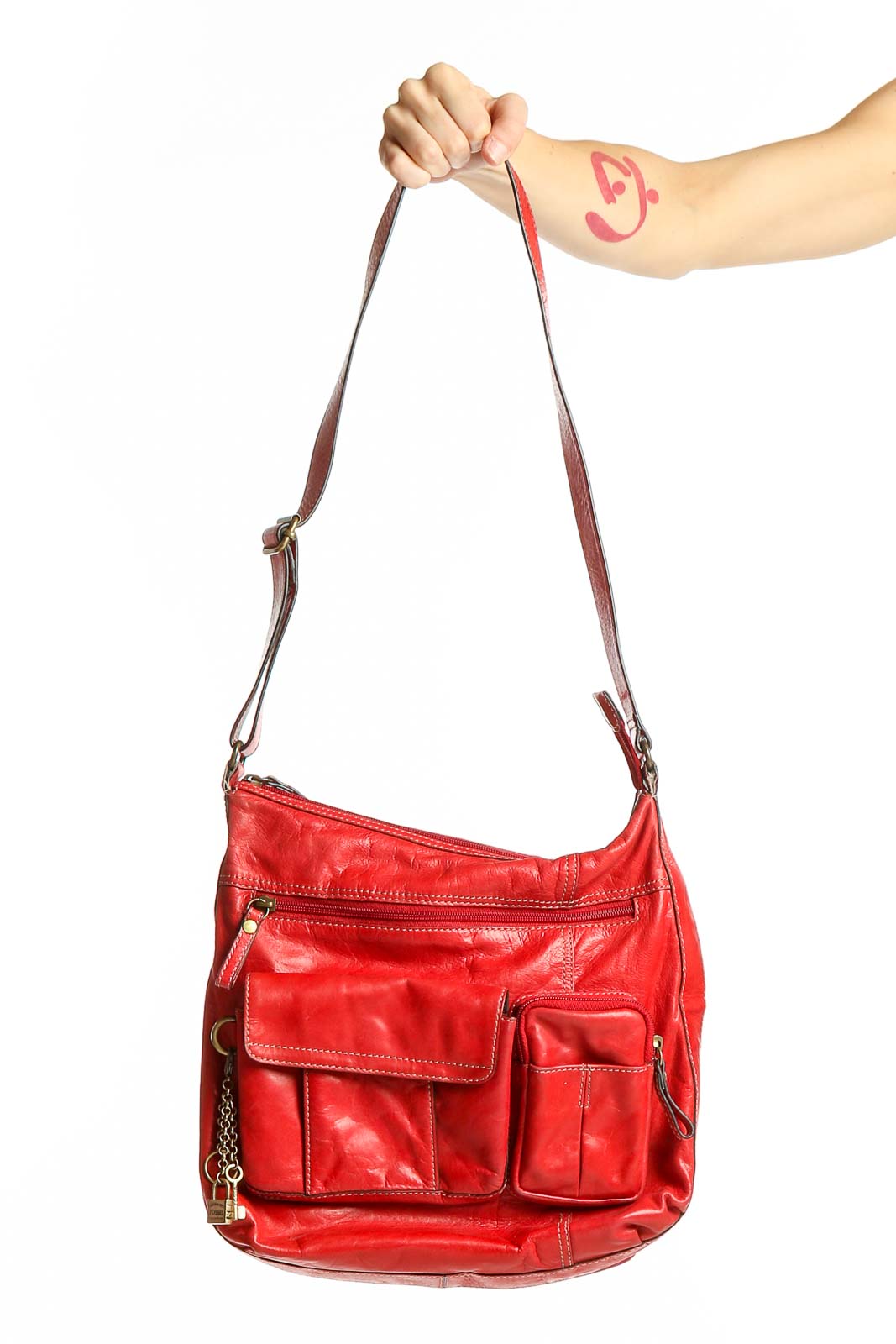 Front view of red leather Fossil crossbody bag with multiple pockets