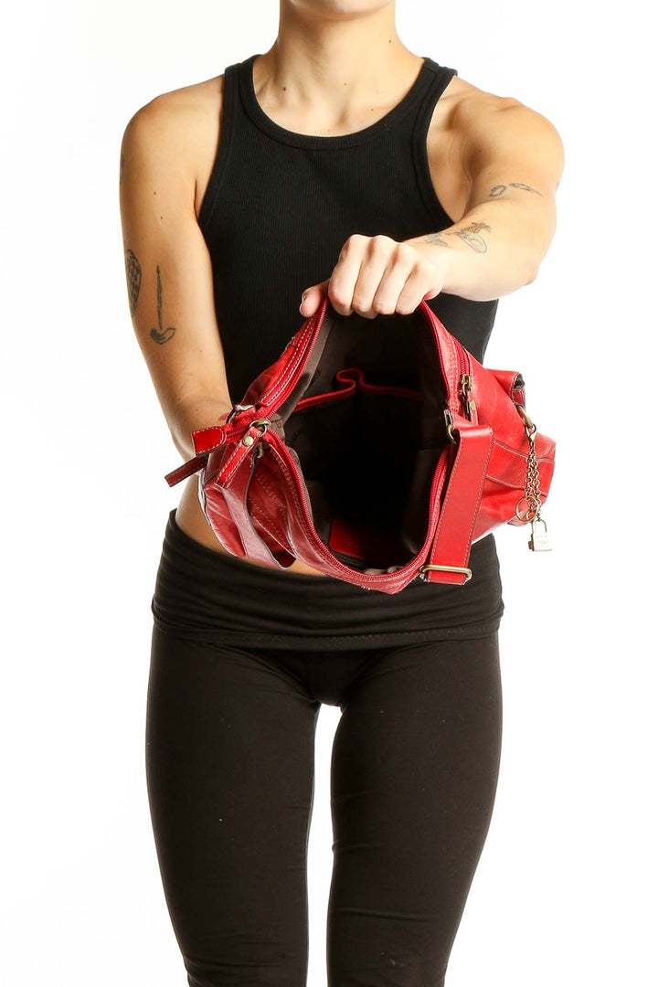 Side view of person wearing red leather Fossil crossbody bag