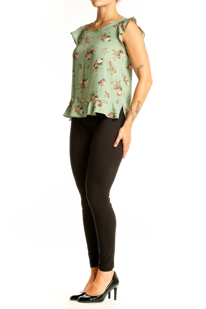 Front view of sage green LOFT blouse with floral print and ruffle sleeves