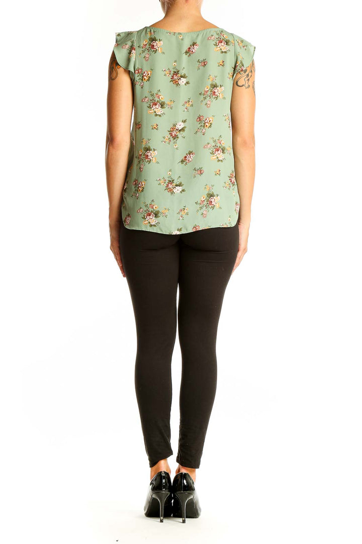 Back view of sage green LOFT blouse showing peplum hem and floral pattern