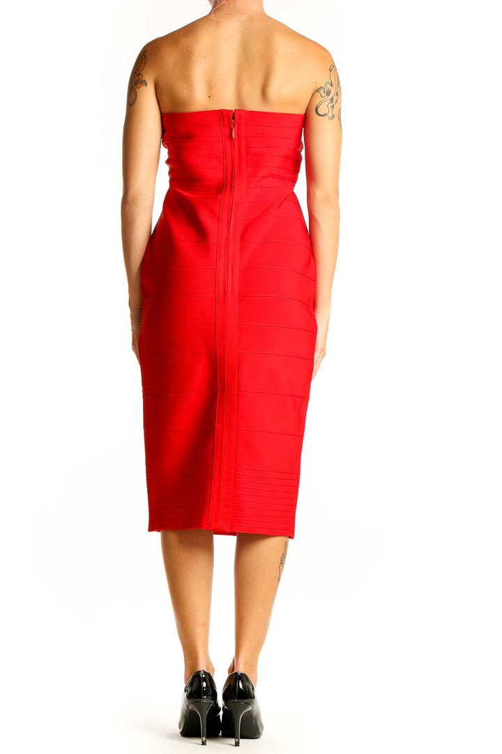 Side view of red strapless bodycon midi dress showing figure-hugging silhouette