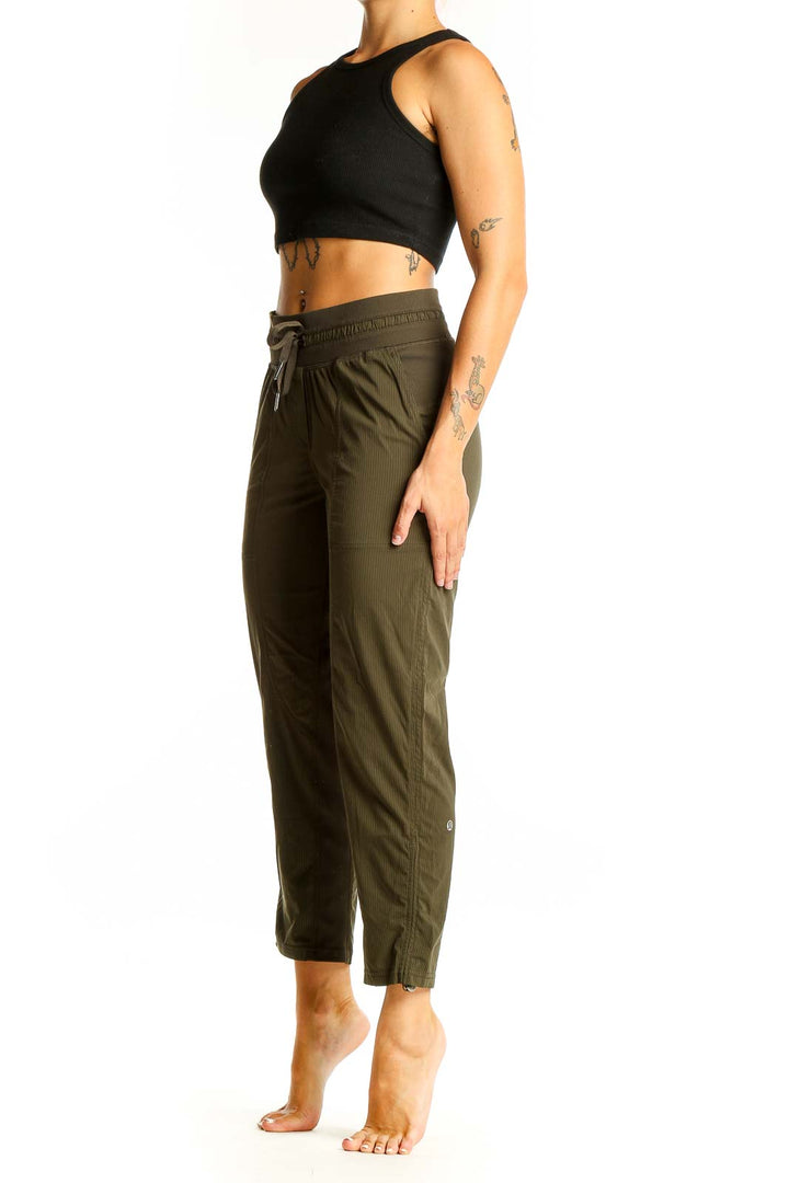 Front view of olive green Lululemon cropped pants with drawstring waist