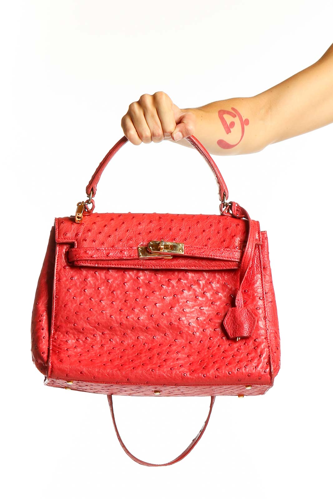 Front view of red ostrich leather satchel with gold-tone hardware