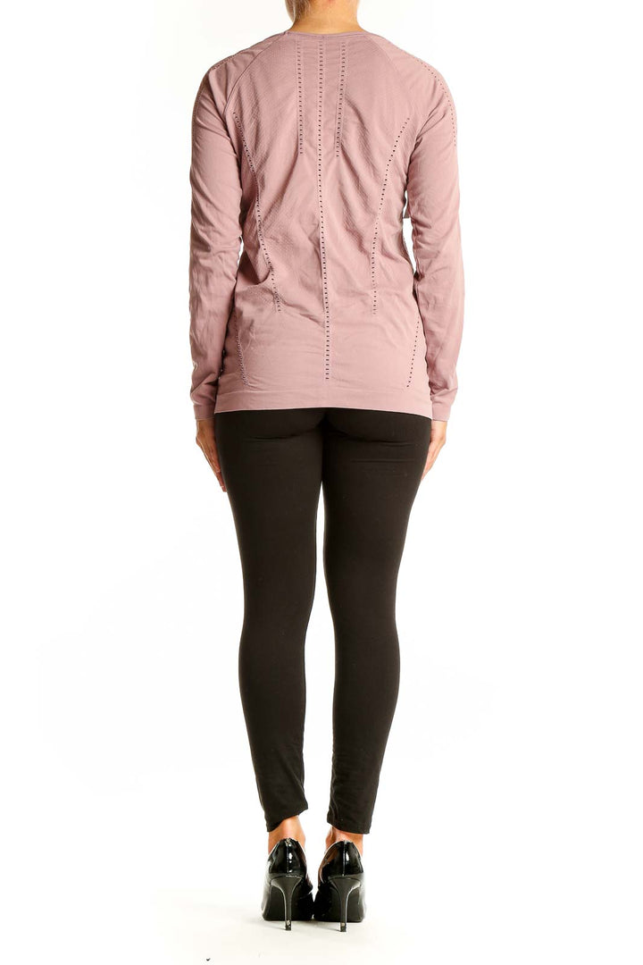 Back view of pink Athleta long sleeve performance top showing raglan sleeves