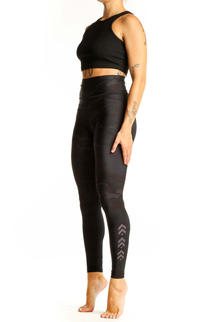 Front view of Barrys black camo high-waisted leggings on model