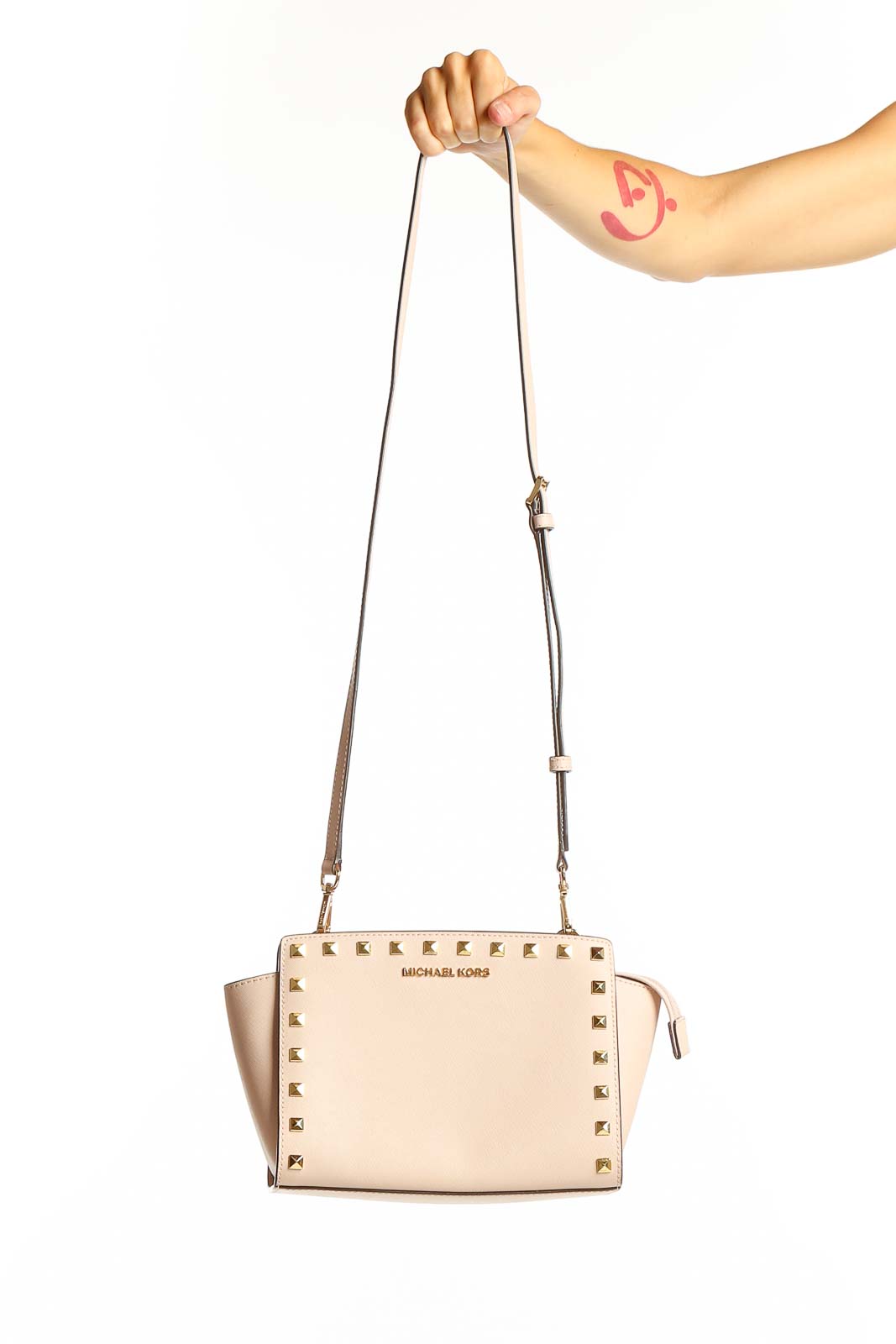Front view of Michael Kors beige studded leather crossbody bag