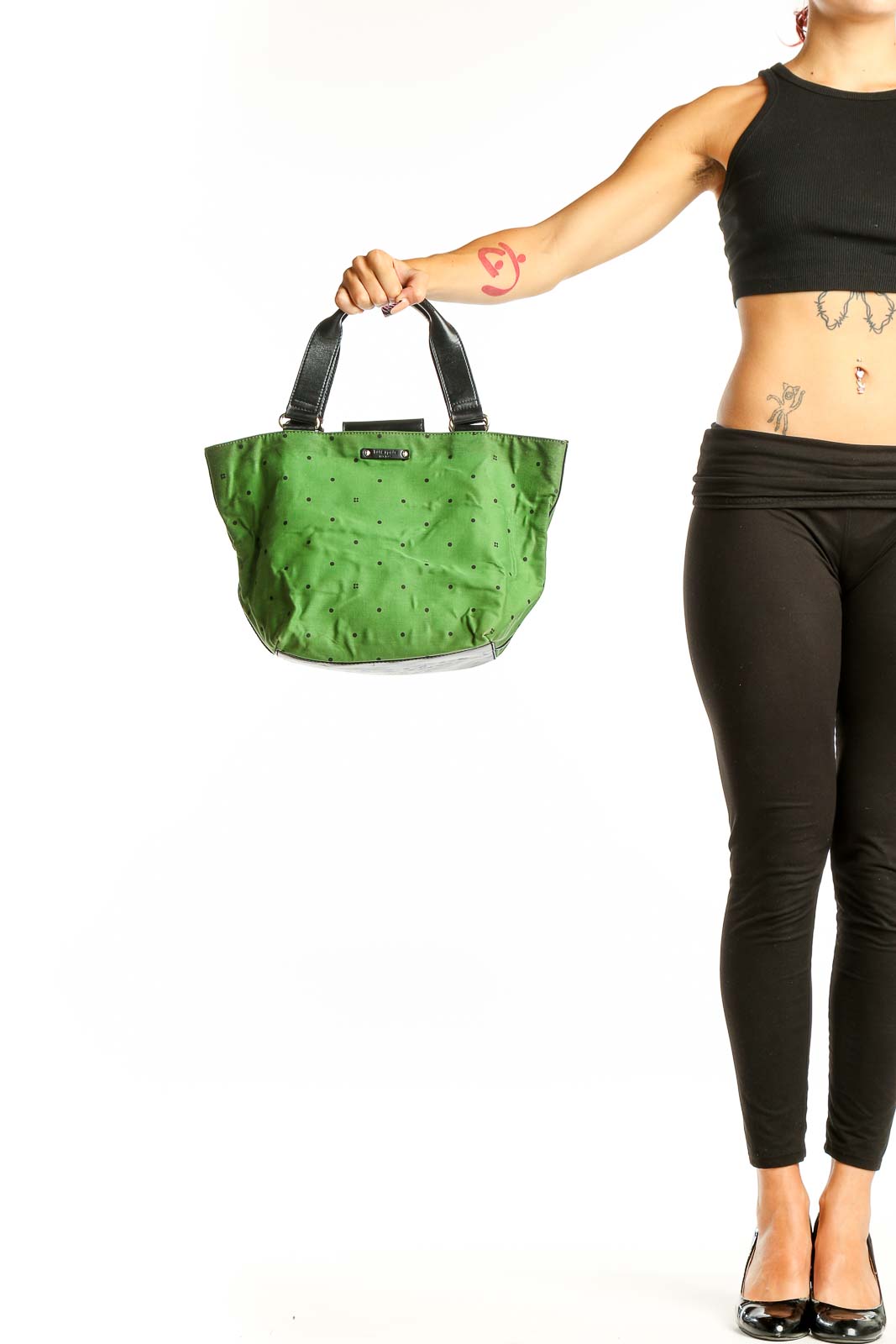 Front view of Kate Spade green leather satchel with polka dot pattern