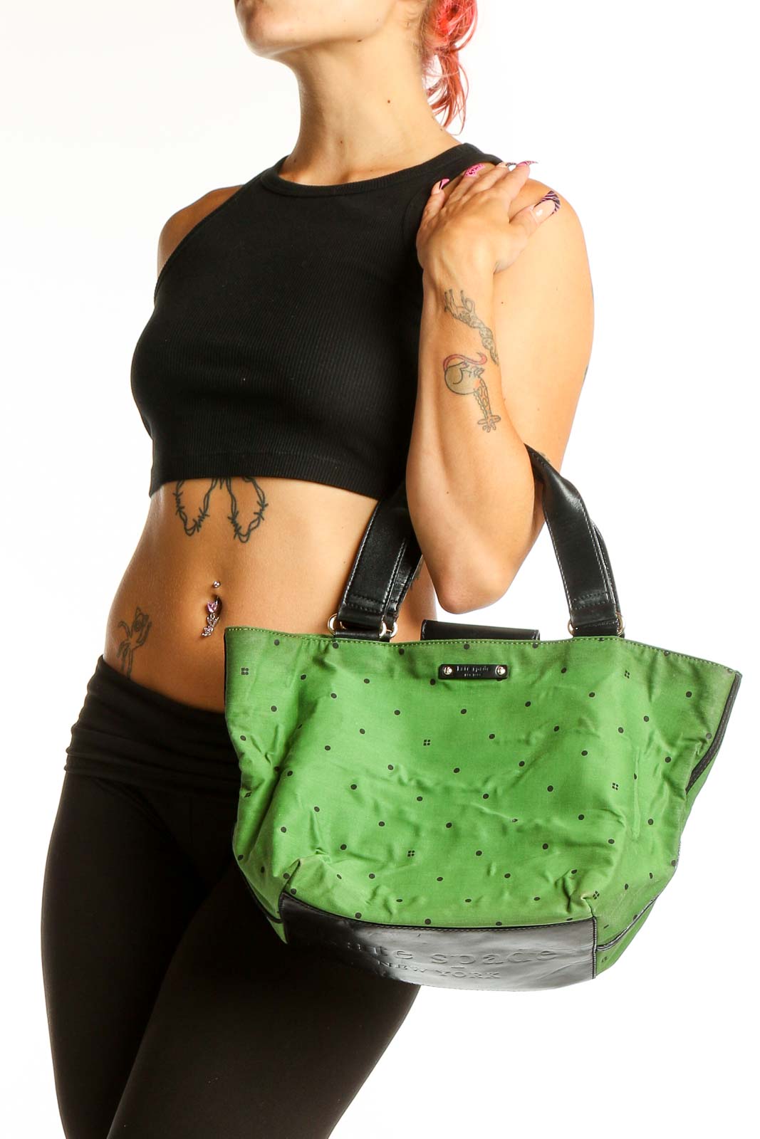 Front view of Kate Spade green leather satchel with polka dot pattern
