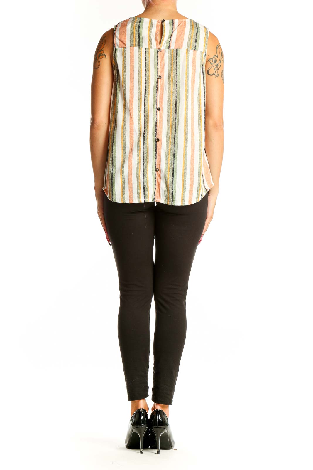 Side view of Eden & Olivia multicolor striped sleeveless blouse paired with black pants
