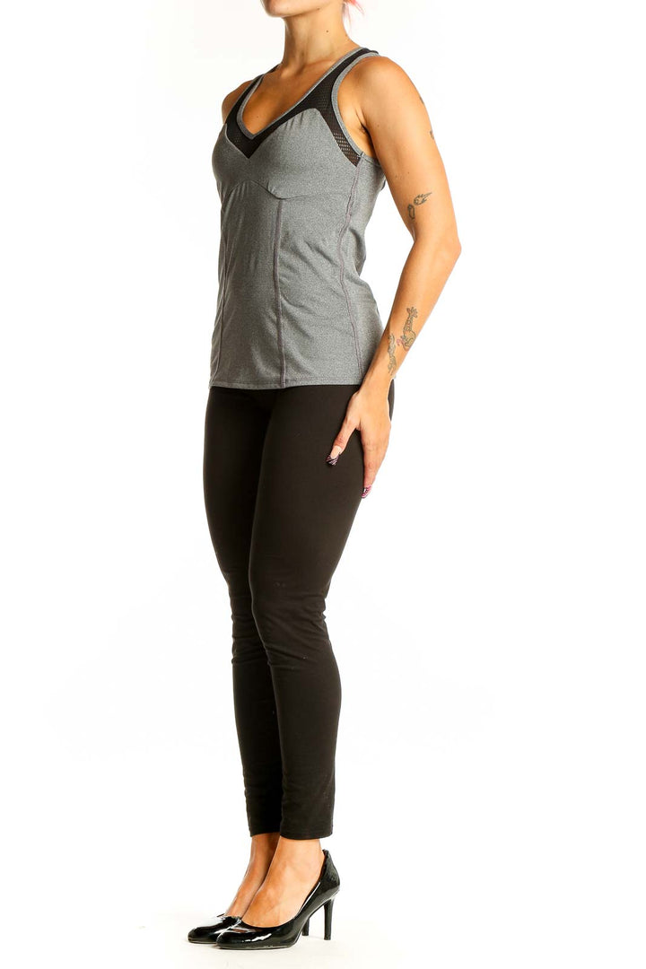 Front view of Trina Turk gray racerback tank top with mesh panel