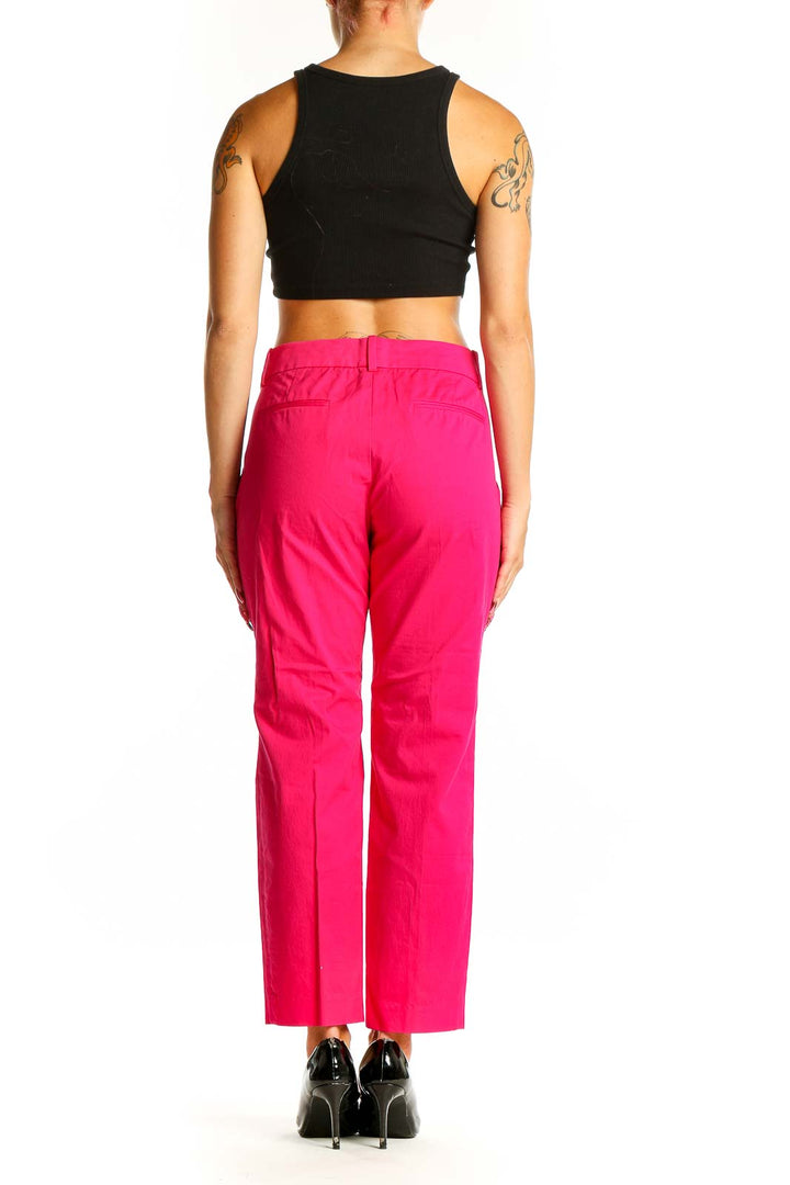 Side view of woman wearing J.Crew hot pink ankle pants with black top