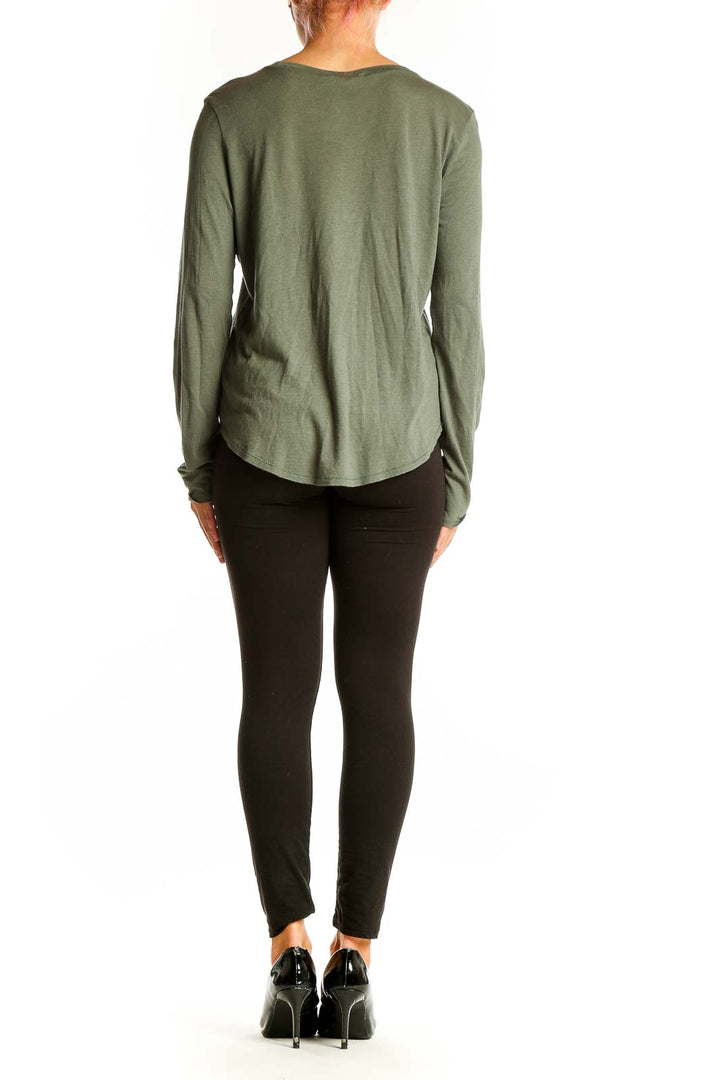 Side view of woman wearing Vince olive long sleeve cotton modal top with black pants