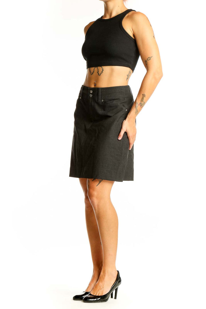 Front view of Athleta black A-line skirt with button detail