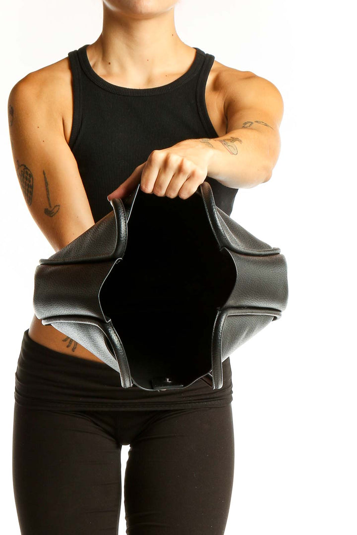 Side view of NEWBELLA black leather hobo tote bag worn on shoulder