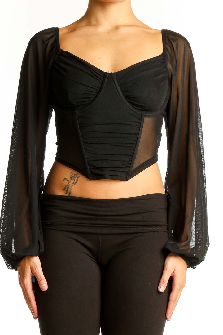 Front view of black crop top with sheer long sleeves and sweetheart neckline