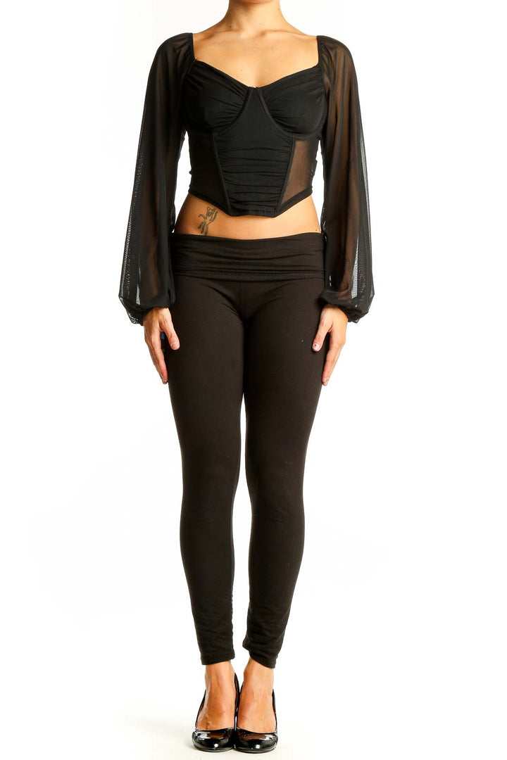 Front view of black crop top with sheer long sleeves and sweetheart neckline