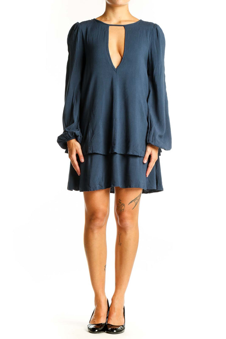 Front view of navy Free People mini dress with plunging neckline and tiered skirt