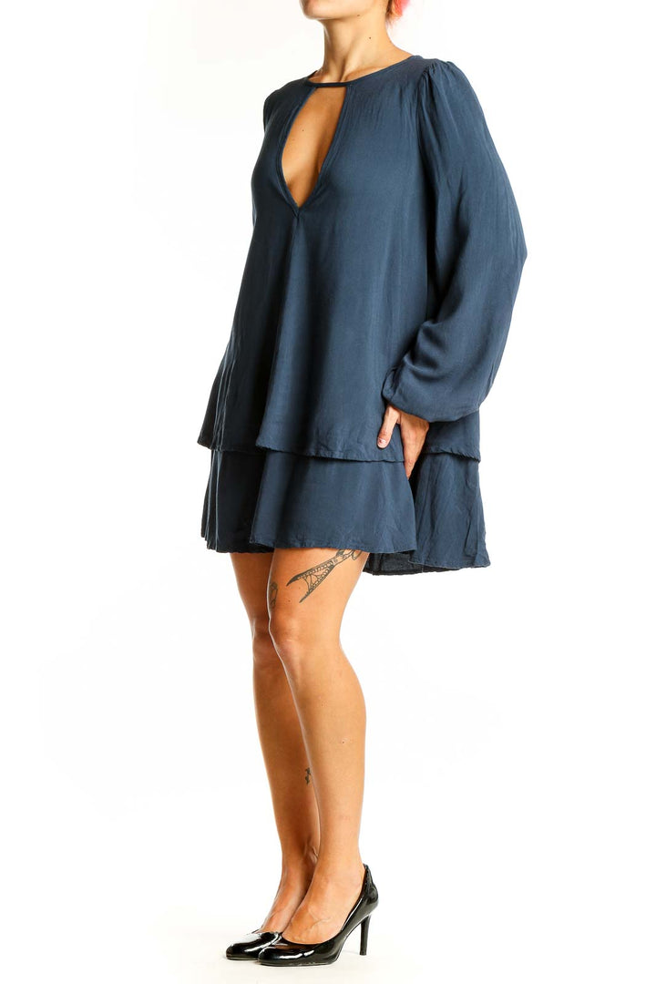 Front view of navy Free People mini dress with plunging neckline and tiered skirt