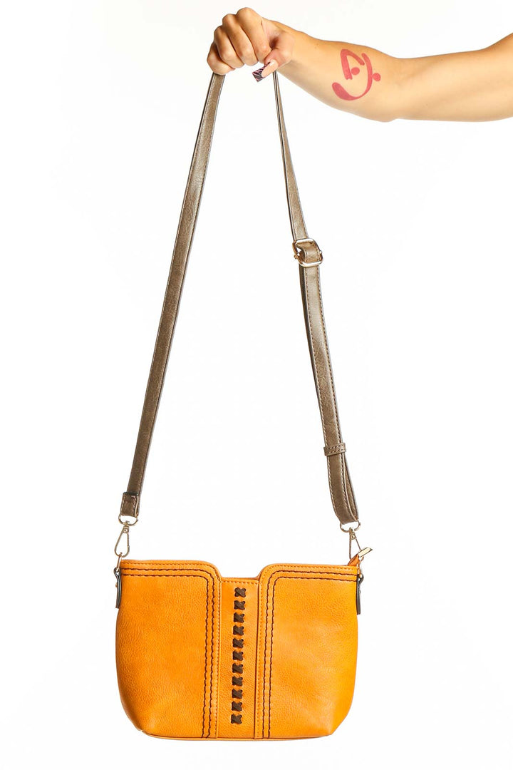 Front view of orange MontanaWest crossbody bag with studded detail