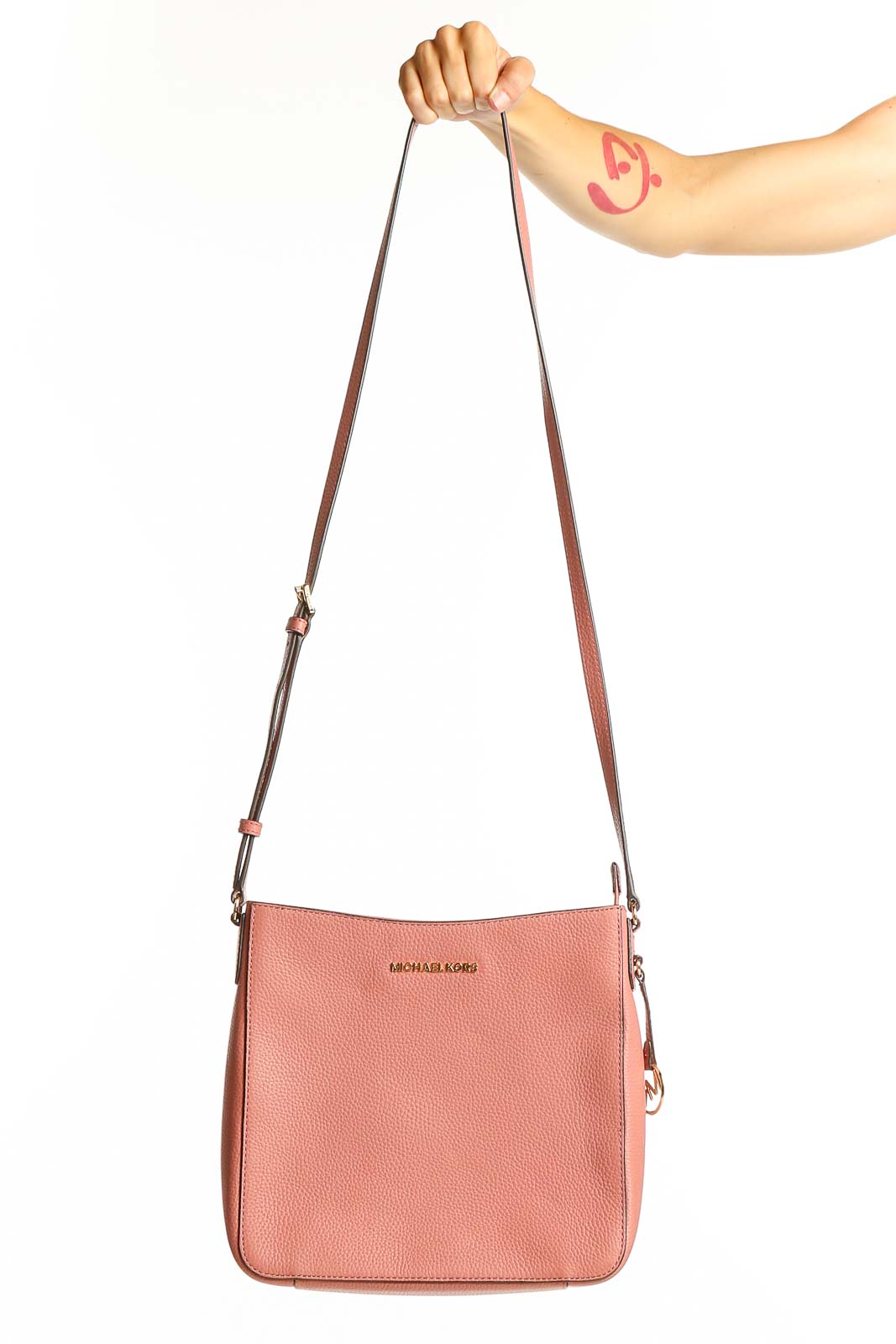Front view of pink leather Michael Kors crossbody bag