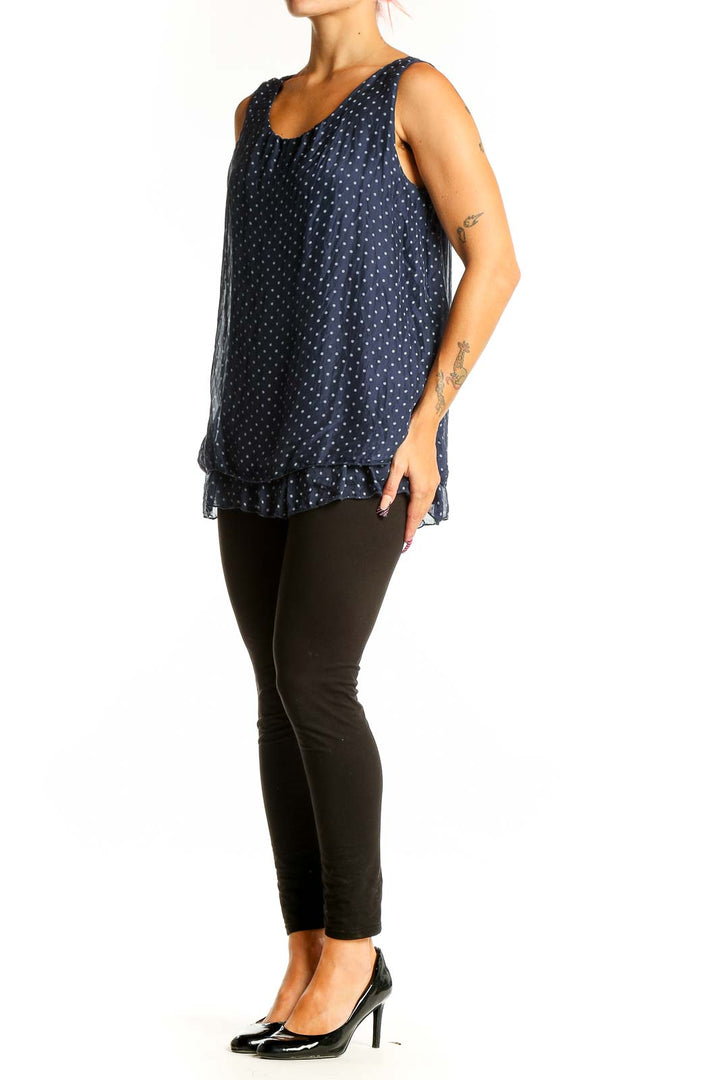 Front view of GIUSY navy sleeveless blouse with white polka dots