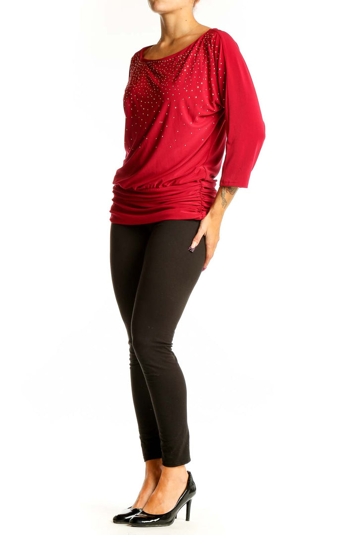Front view of red sparkly dolman sleeve top from White House Black Market
