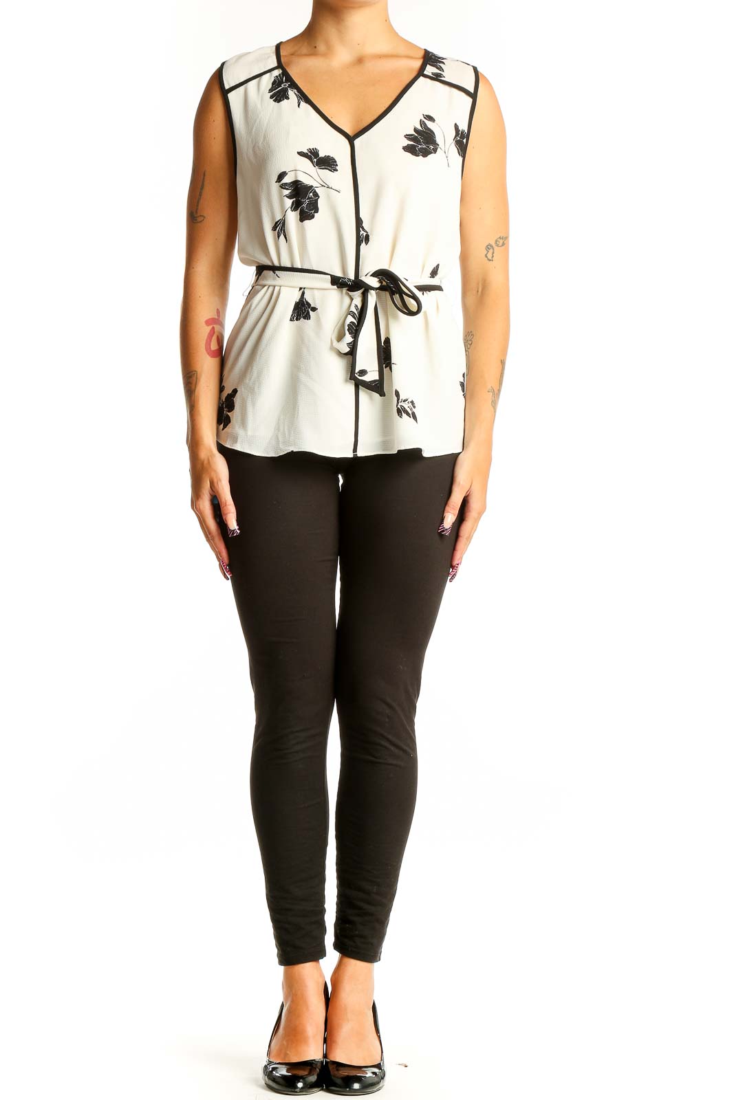 Front view of Vince Camuto white sleeveless blouse with black floral print and tie-waist