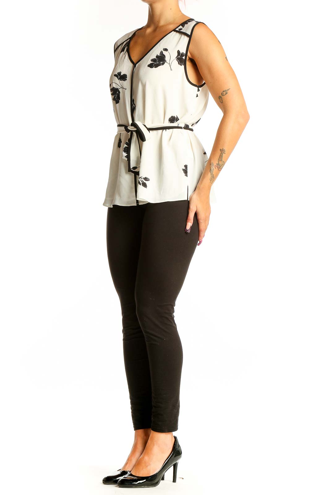 Front view of Vince Camuto white sleeveless blouse with black floral print and tie-waist