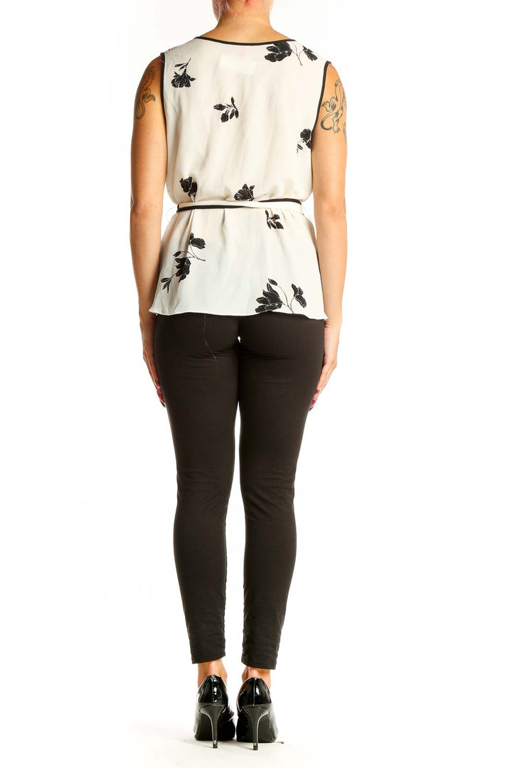 Side view of Vince Camuto white sleeveless blouse showing floral print and flowing silhouette