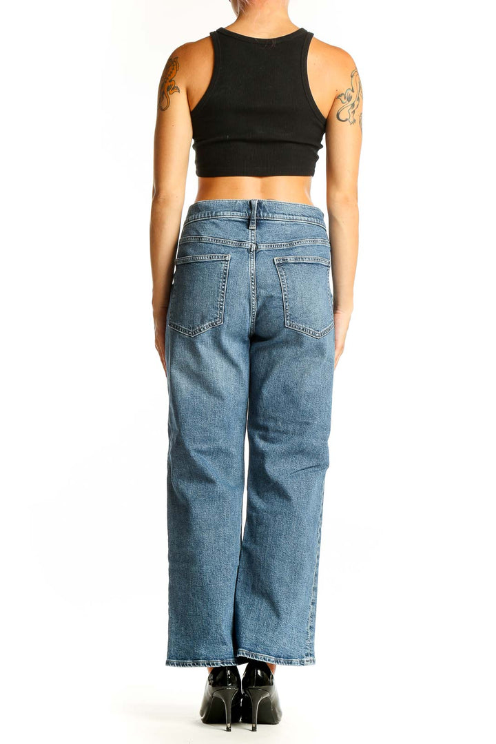Back view of Gap blue wide-leg jeans on model with black crop top