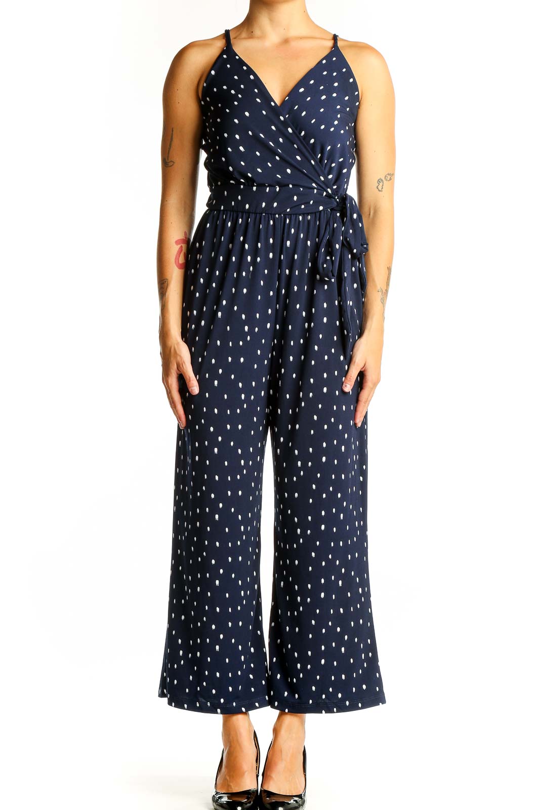 Front view of Kaileigh Navy Polka Dot Wrap Jumpsuit with V-neckline and wide legs