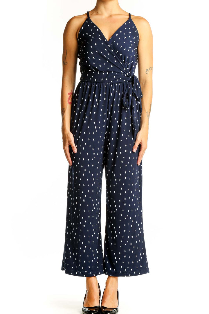 Front view of Kaileigh Navy Polka Dot Wrap Jumpsuit with V-neckline and wide legs