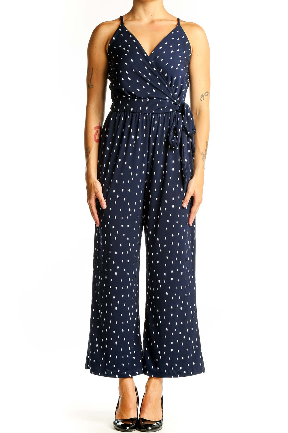Front view of Kaileigh Navy Polka Dot Wrap Jumpsuit with V-neckline and wide legs