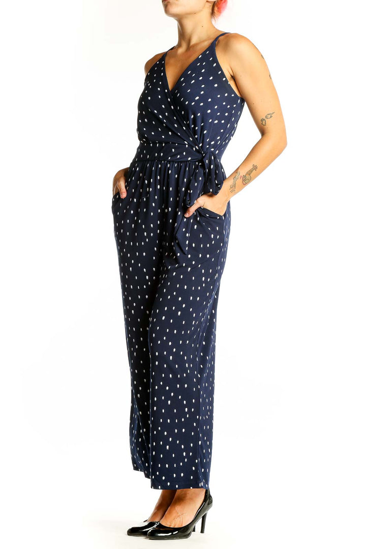 Front view of Kaileigh Navy Polka Dot Wrap Jumpsuit with V-neckline and wide legs