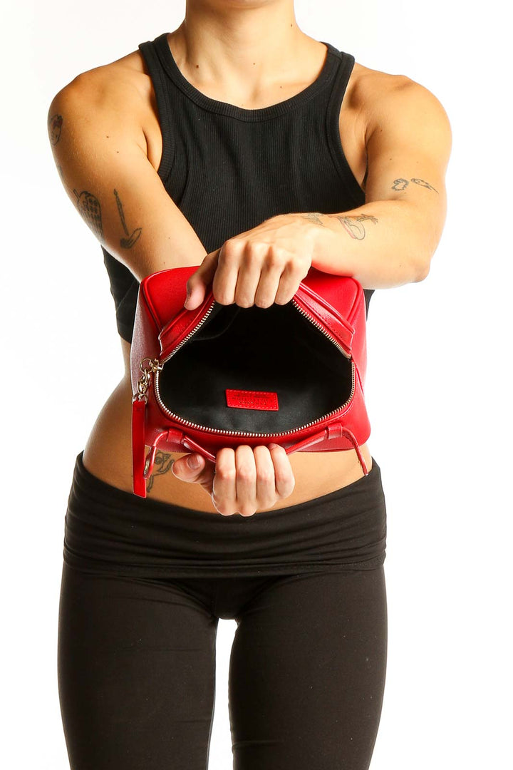 Model wearing red Versace leather crossbody bag with black outfit